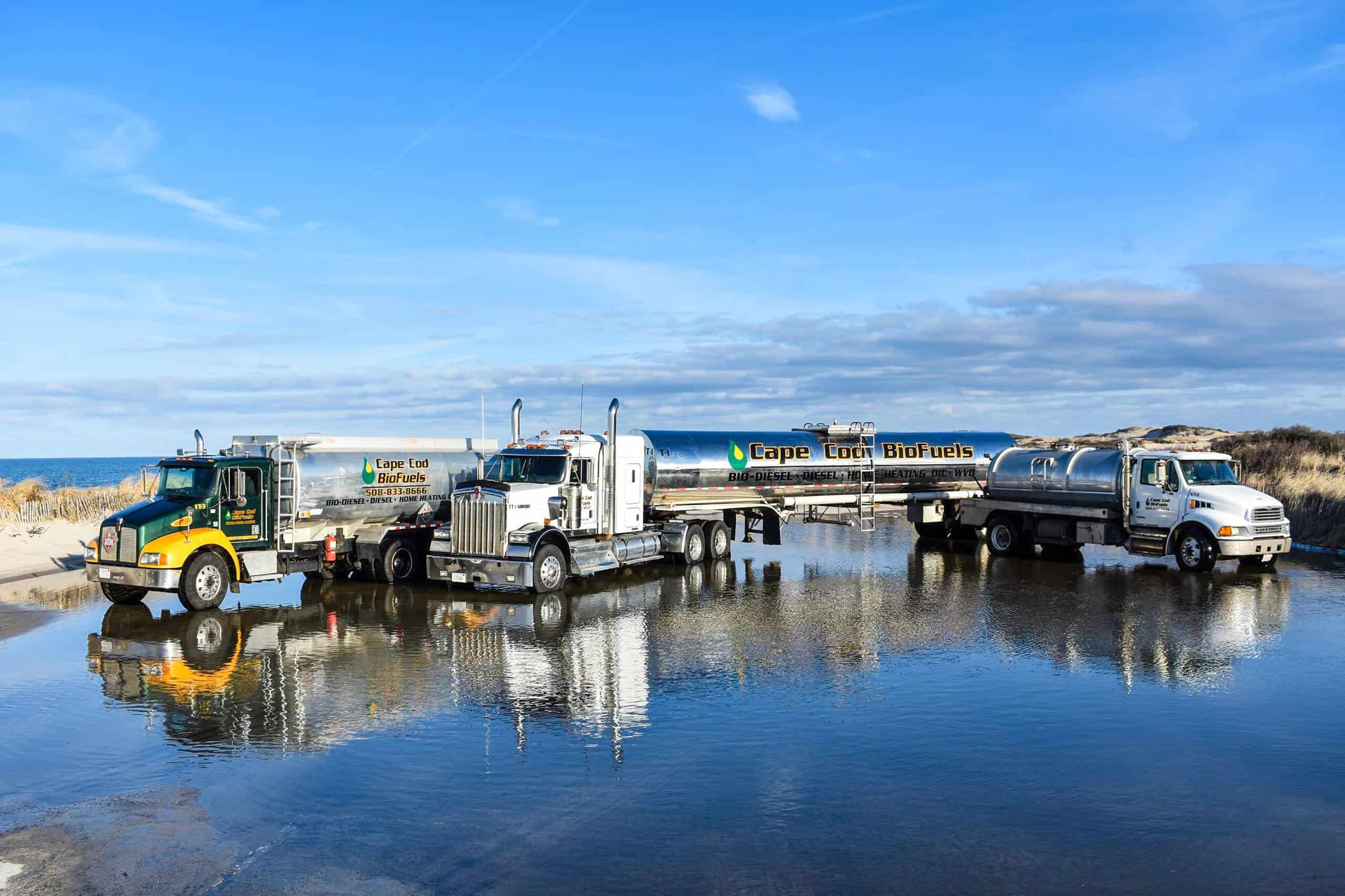 Cape Cod Biofuels delivery trucks parked by the water on Cape Cod