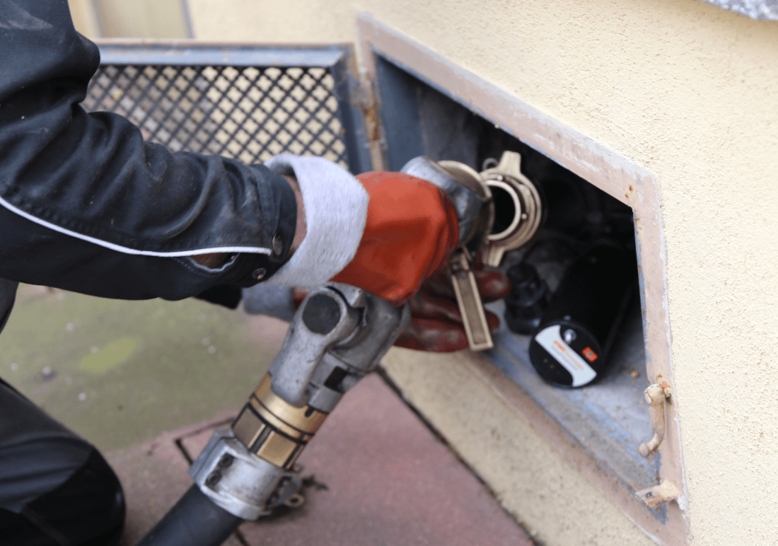 Renewable Bioheat fuel being pumped into a home heating oil fill pipe